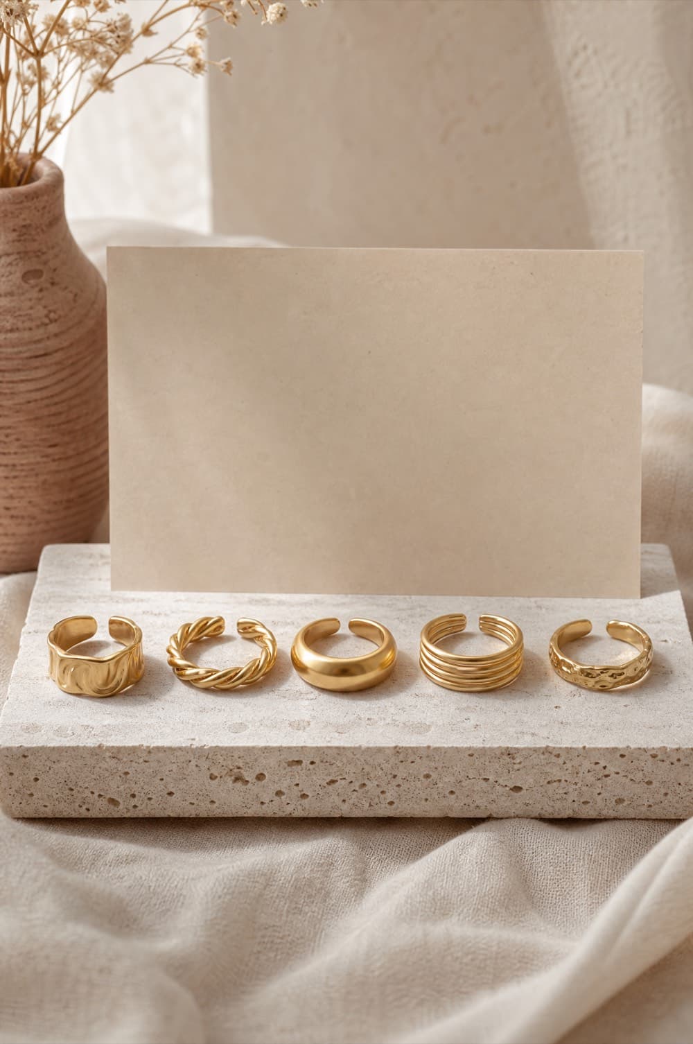 Five open adjustable gold-tone rings arranged in a row