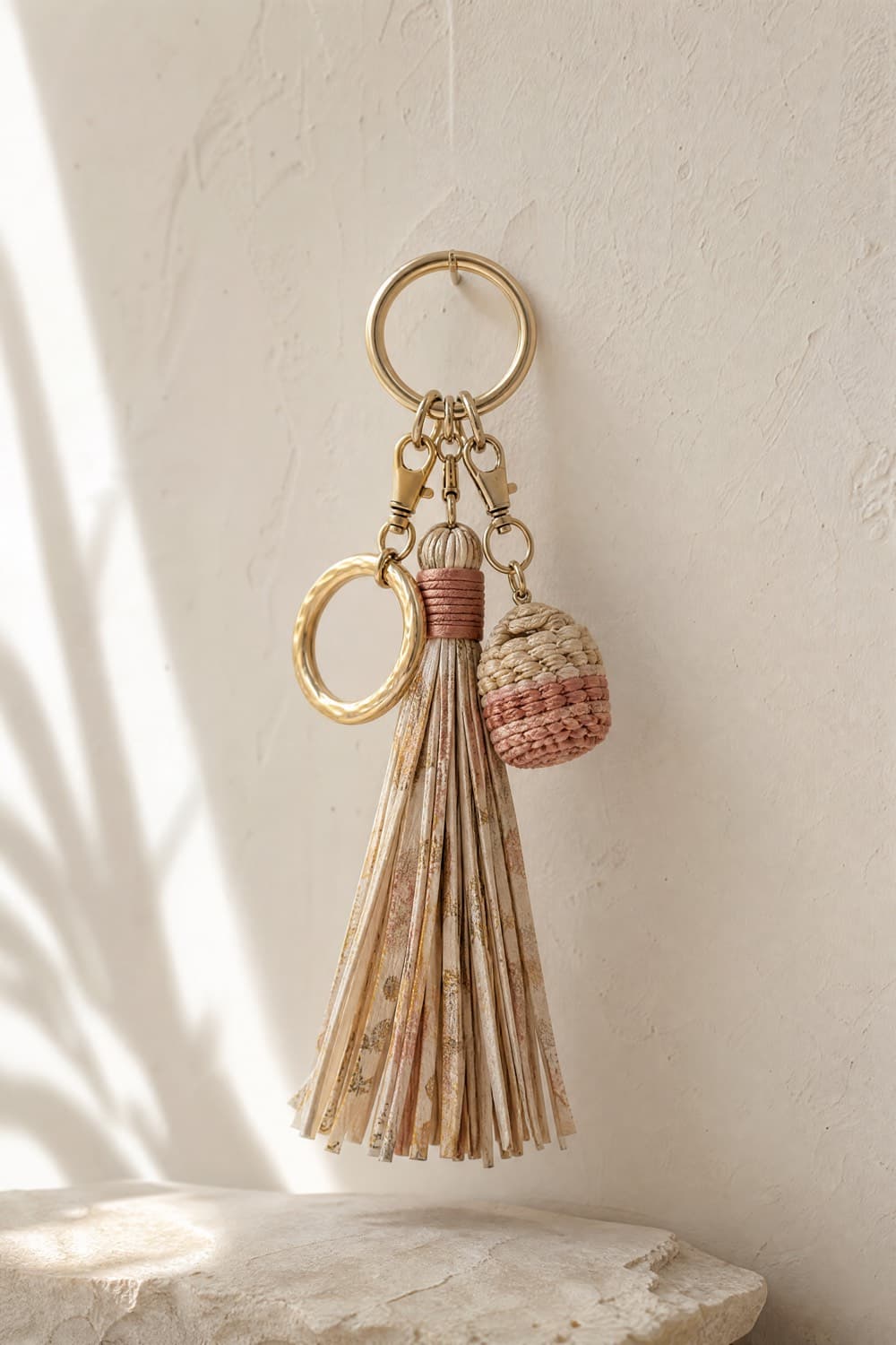 Tassel, ring and woven bag charms hanging from a bag ring