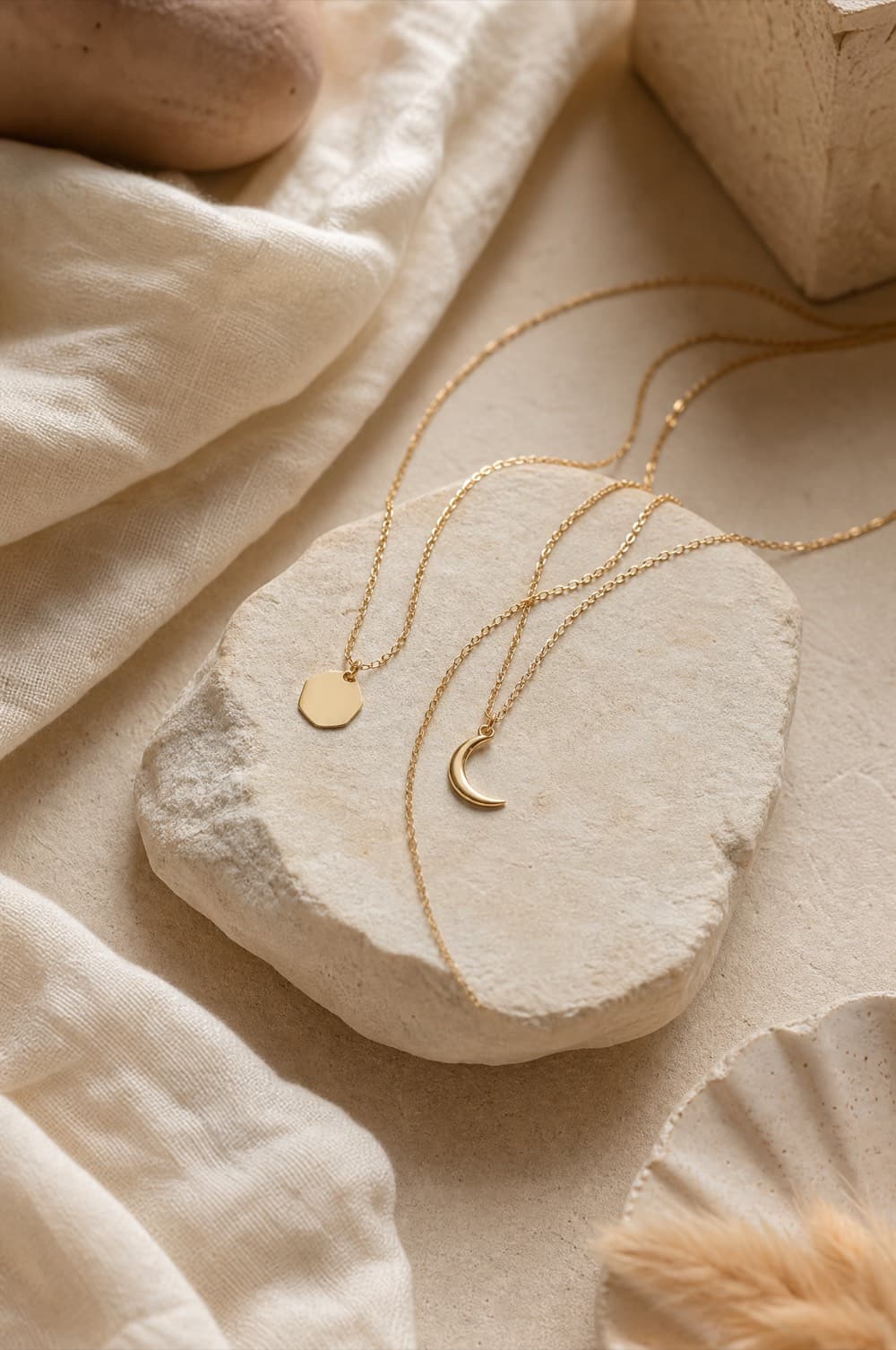 Two fine pendant necklaces with geometric and crescent charms